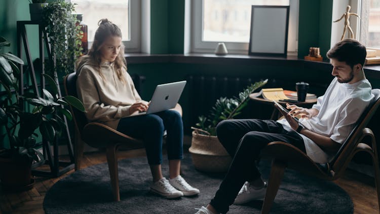 Photo Of Two People Using Their Gadgets