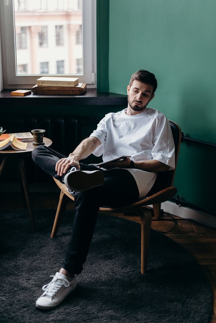 Man In White Shirt Sitting On Chair