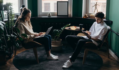 Free Two Persons Using Their Gadgets Stock Photo