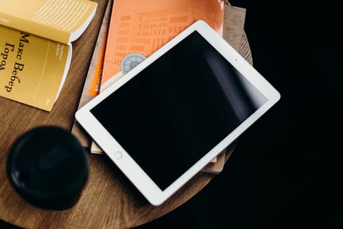 White Ipad on Brown Wooden Table