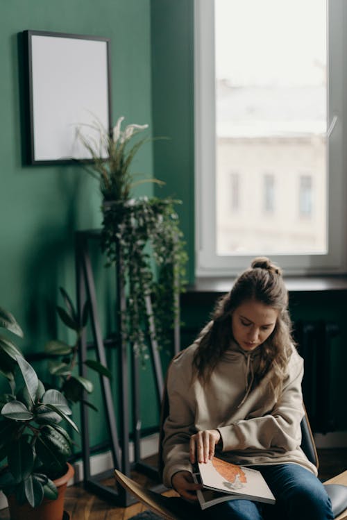 Free Woman in Brown Coat Standing Near Green Plant Stock Photo