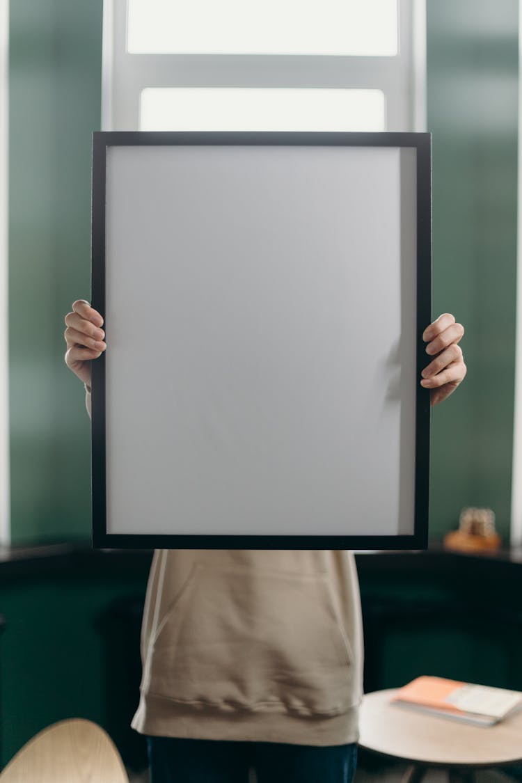 Person Holding White And Black Frame