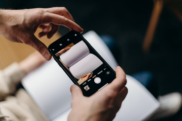 Person Holding Black Iphone 4