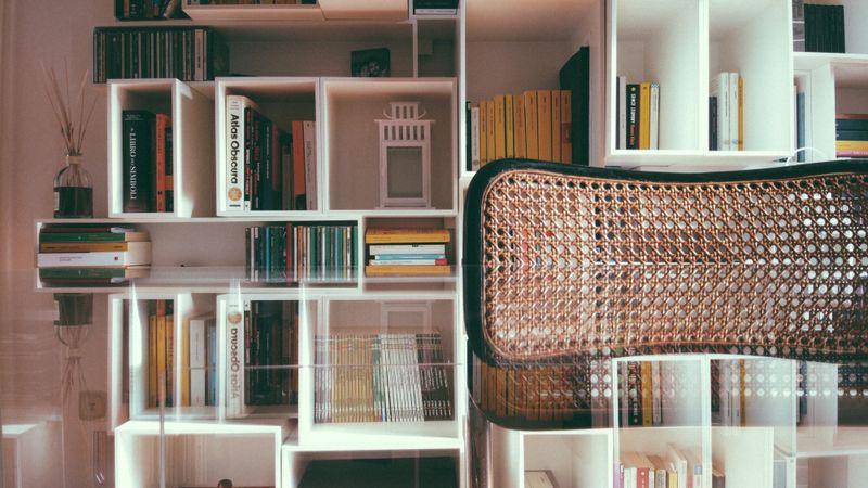warm string lights draped along a shelf behind a desk
