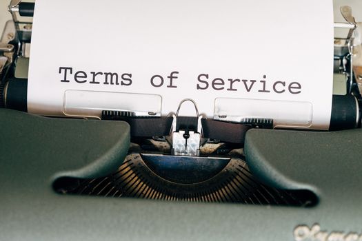 Black and Green Typewriter with White Paper
