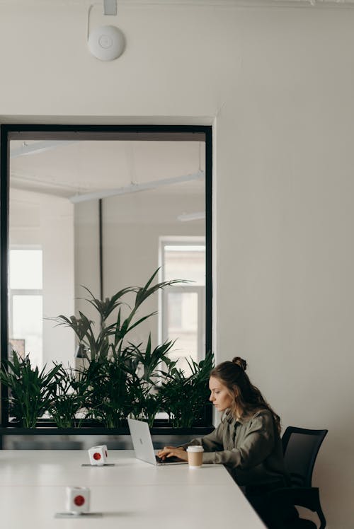 Woman Sitting on Chair While Using Laptop