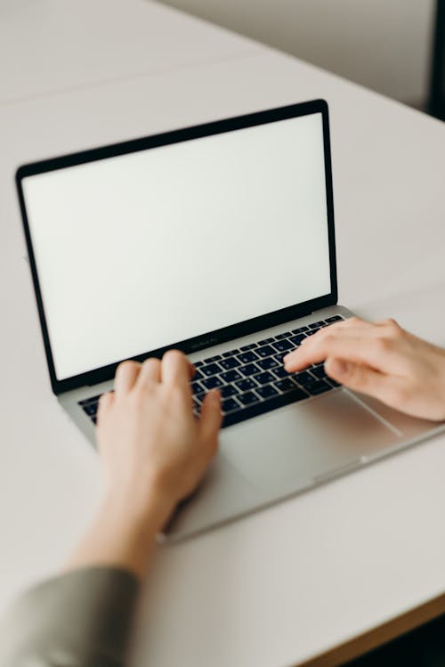 Free Person Using a Macbook  Stock Photo