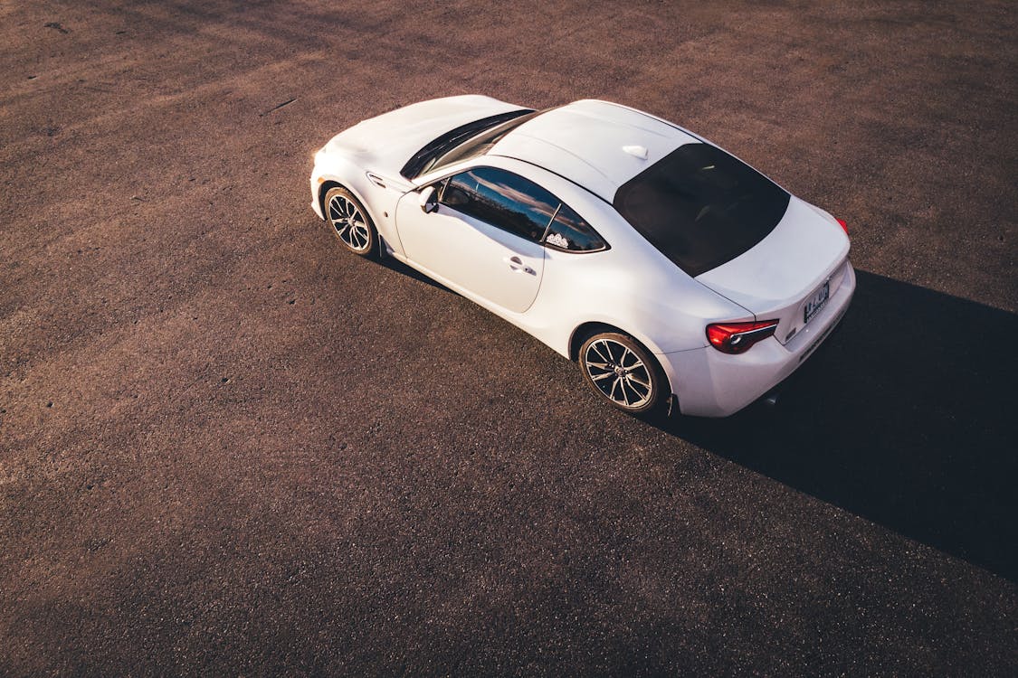 Free Photo Of White Car Parked On Pavement Stock Photo