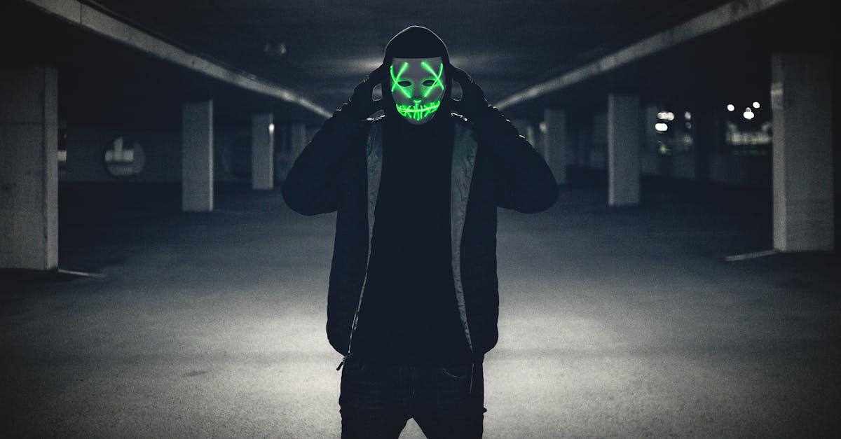 Man in Black Hoodie Wearing Green Mask · Free Stock Photo