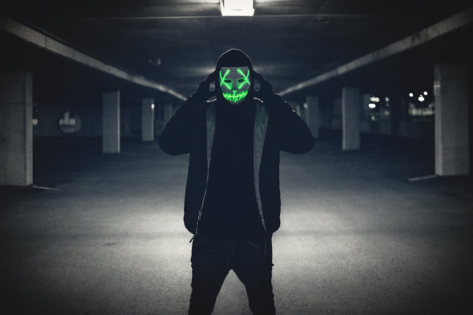 Man in Black Hoodie Wearing Green Mask · Free Stock Photo