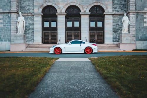 Photo Of White Car Parked Near Stairs