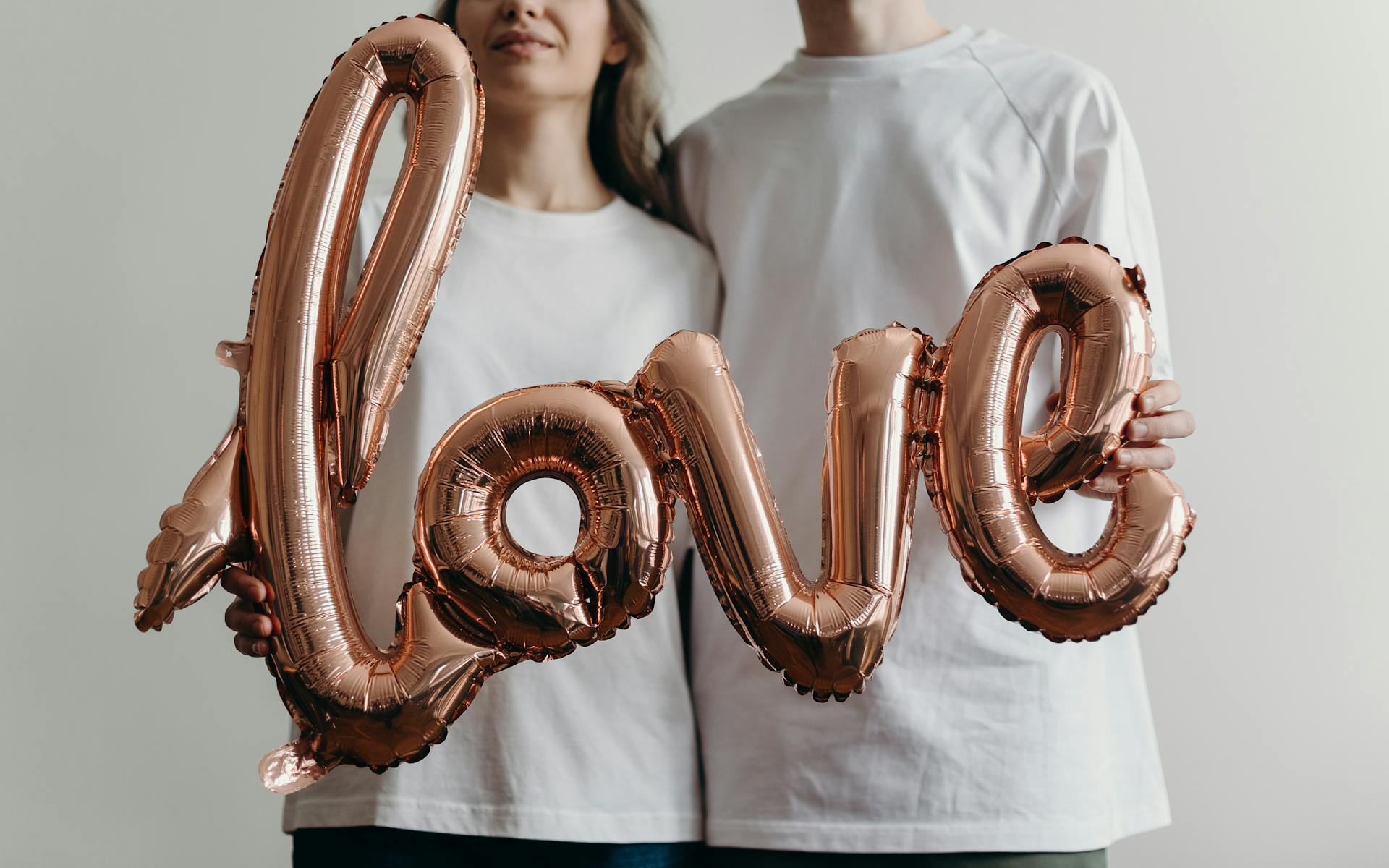 Woman in White Crew Neck Shirt With Brown and White Heart Shaped Beaded Necklace