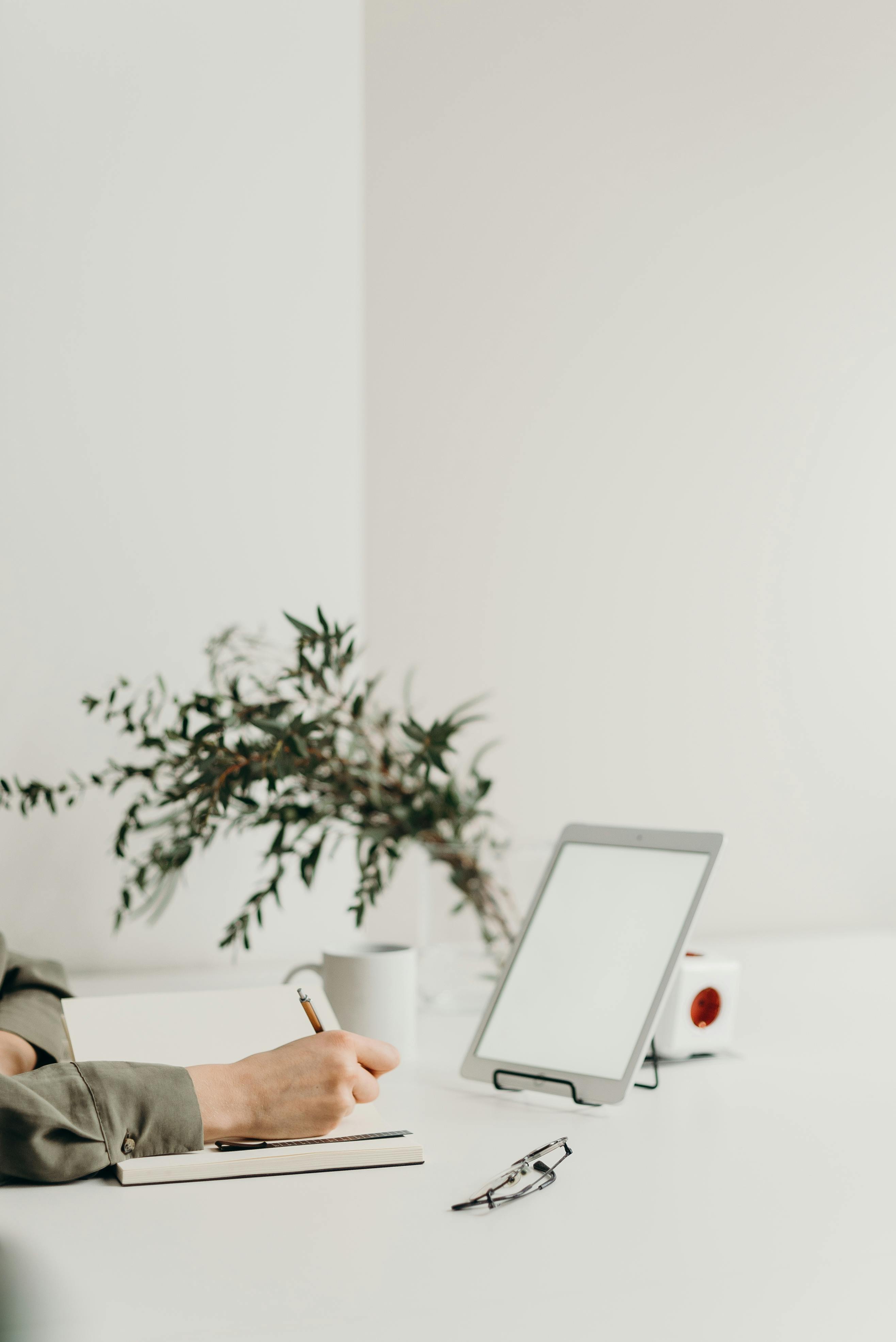 person holding white tablet computer