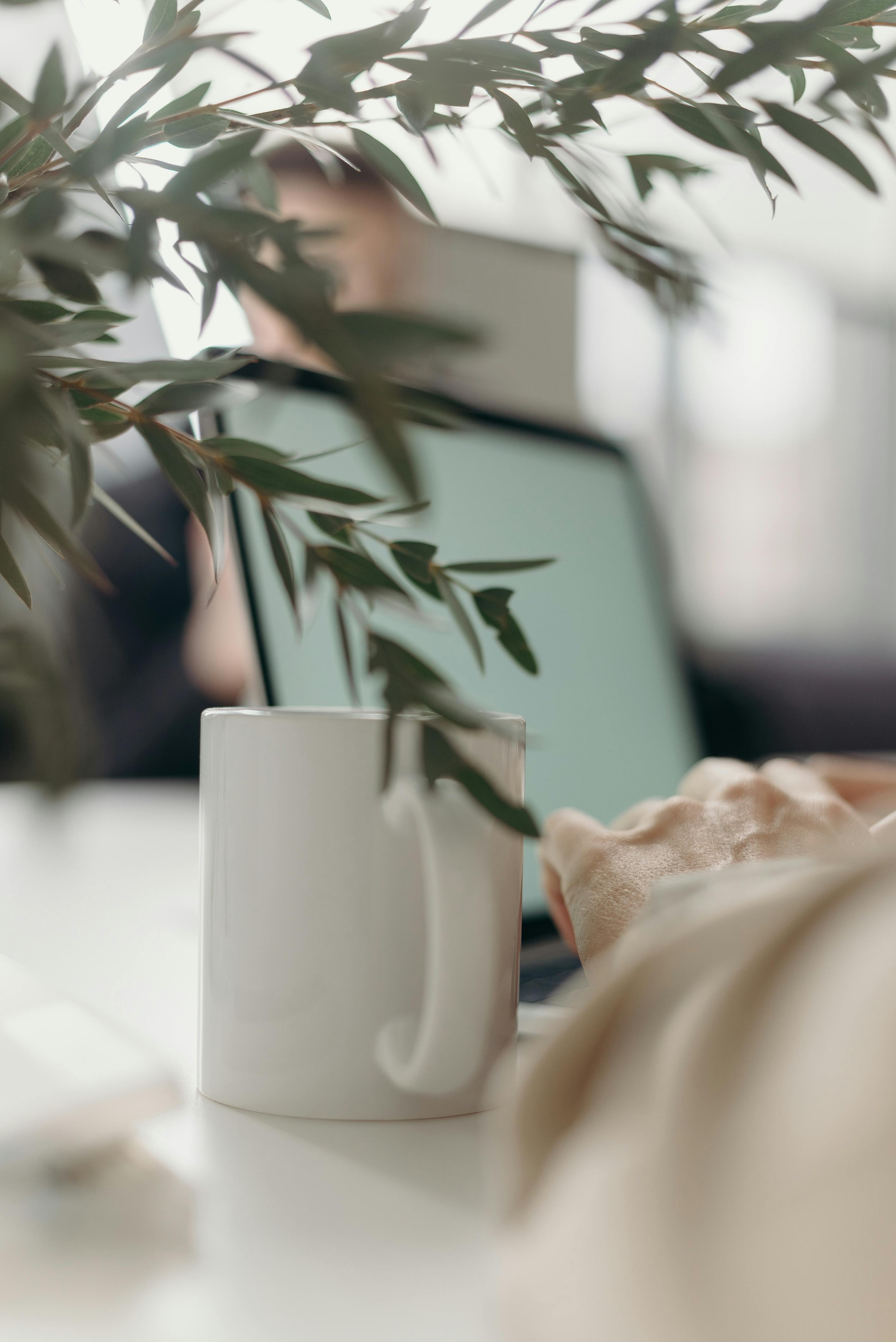 white ceramic mug on white table