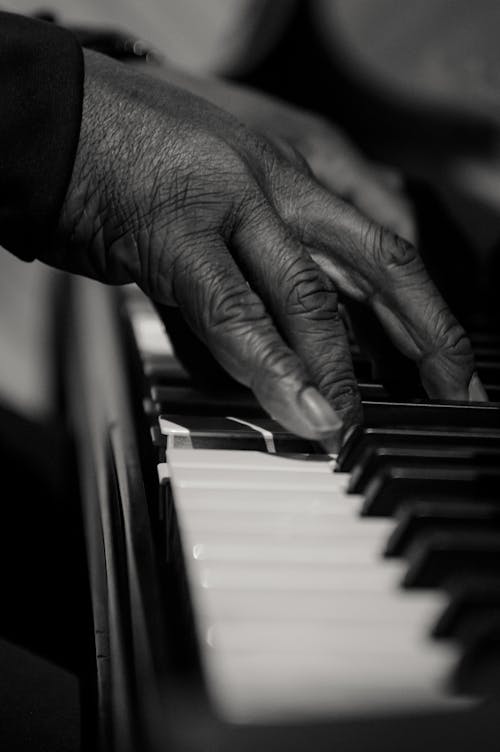 Free Person Playing Piano in Grayscale Photography Stock Photo