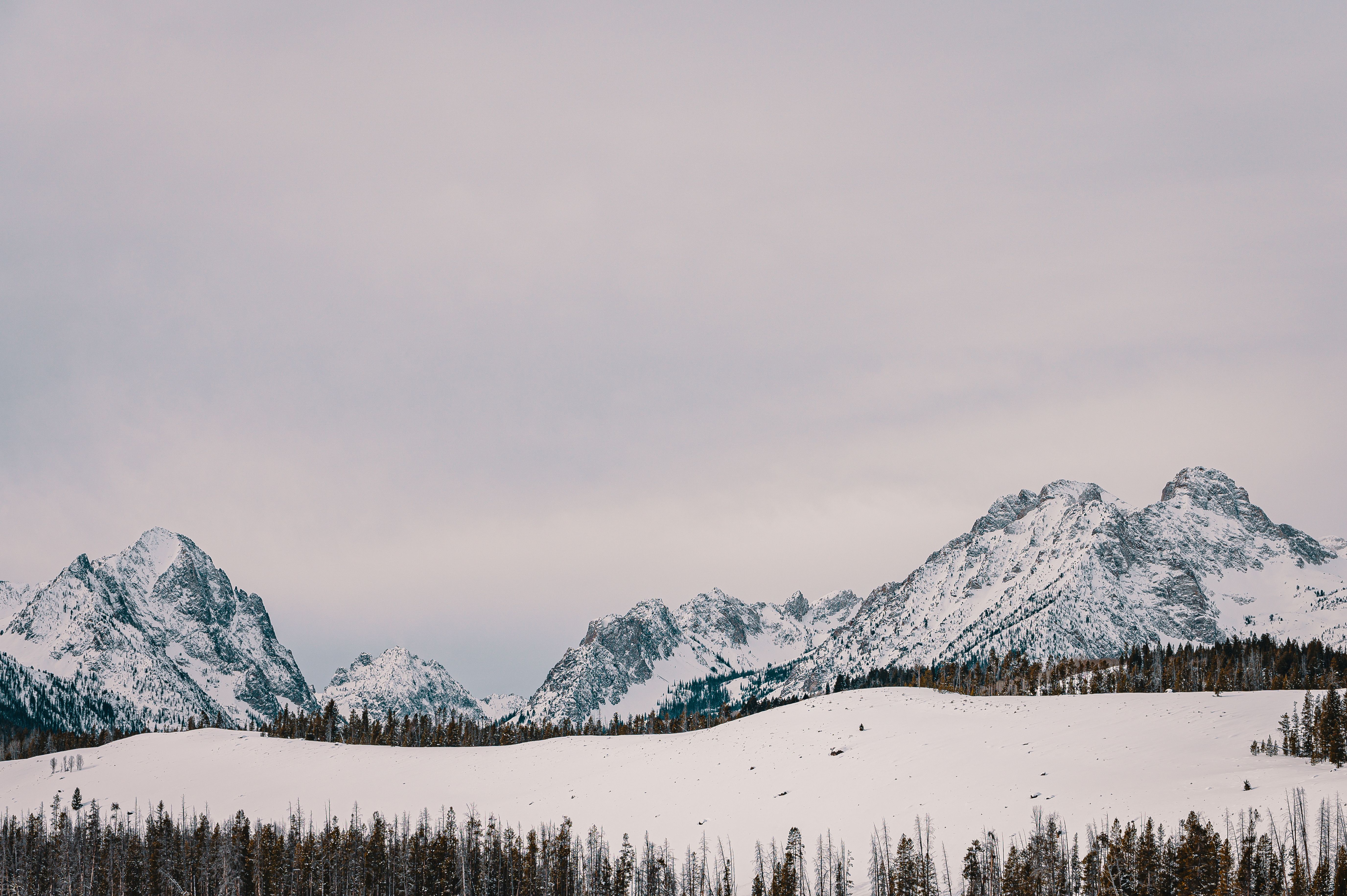 Snow Covered Mountain Under Cloudy Sky · Free Stock Photo