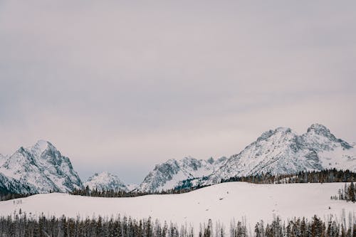 Snow Covered Mountain Under  Cloudy Sky