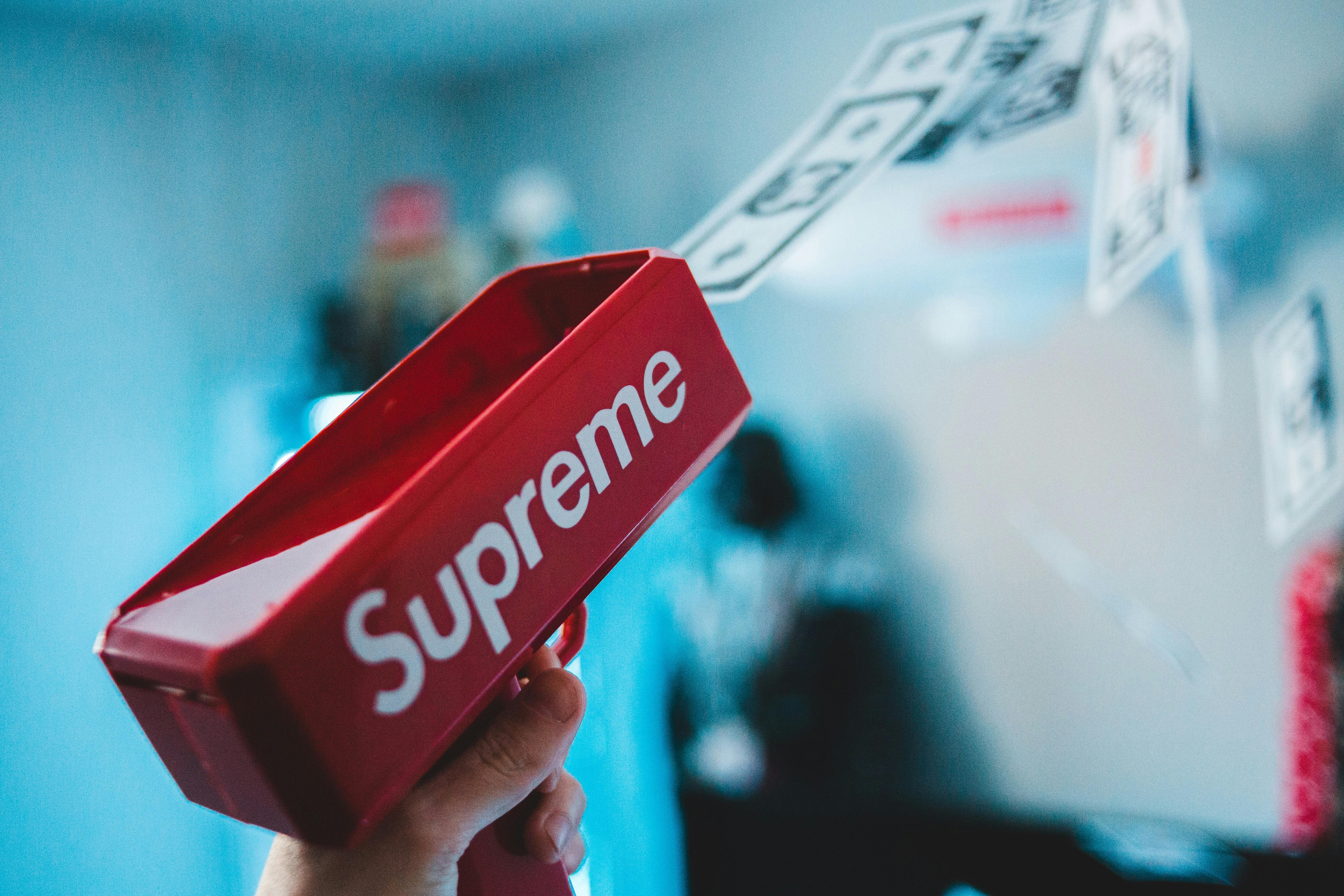 Person Holding Supreme Cash Cannon · Free Stock Photo