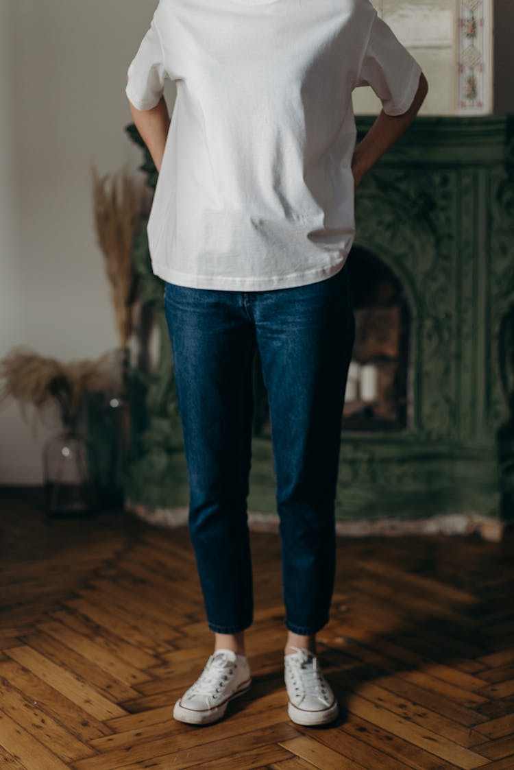 Photo Of Person Wearing White T-Shirt And Blue Denim Jeans