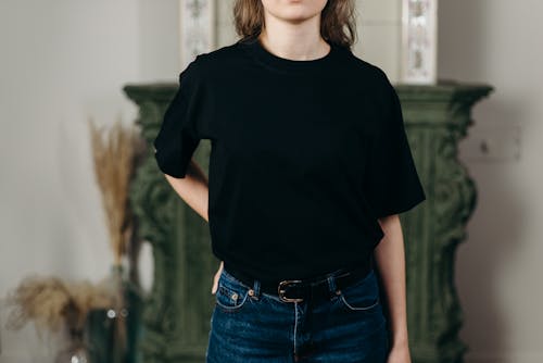 Free Person Wearing Black T-Shirt and Denim Jeans Stock Photo
