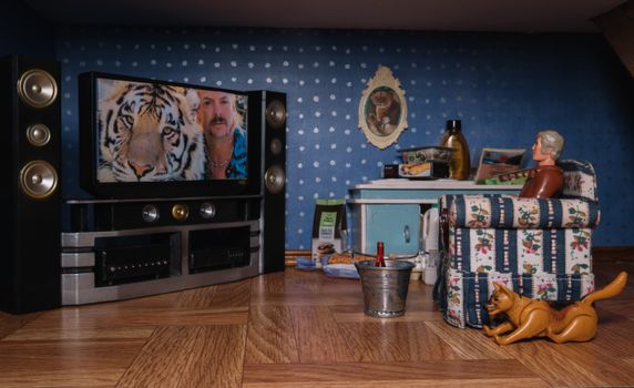Diorama of a living room featuring a TV, toys, and themed decor.