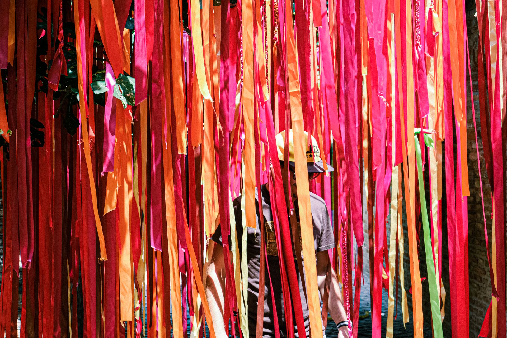 Vibrant red and orange ribbons create a festive outdoor installation accentuating the sunny atmosphere.