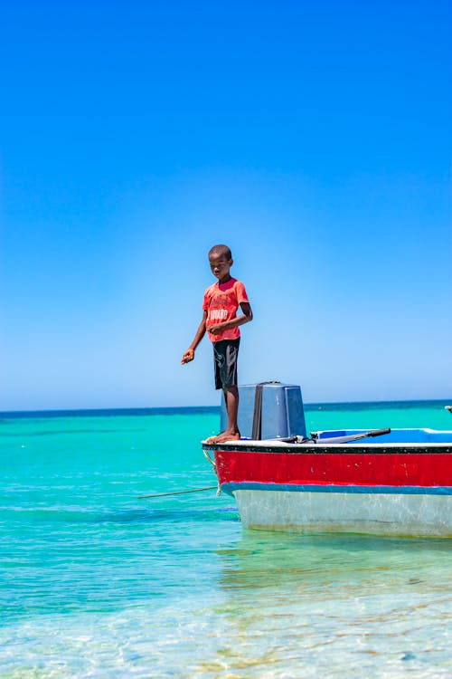 Boy Standing on Boat