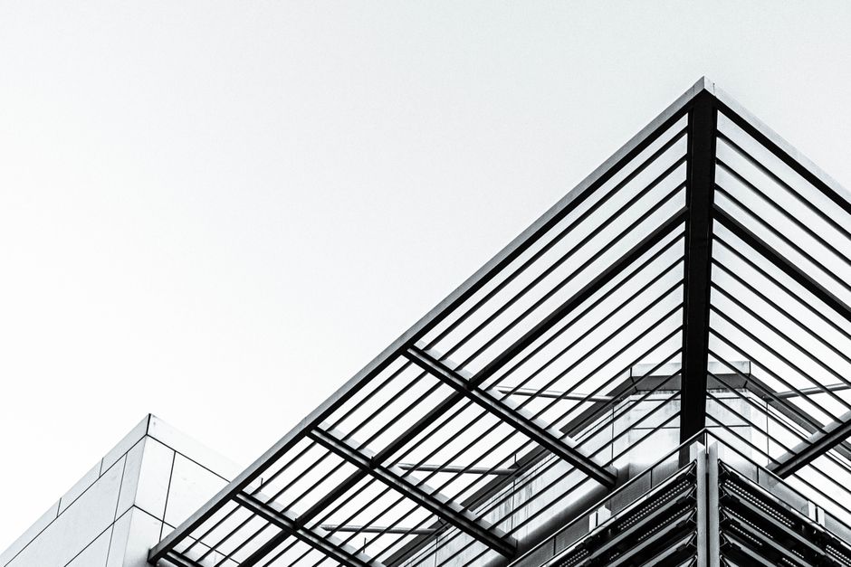Low angle shot of a modern building with steel and glass design in Port of Spain.