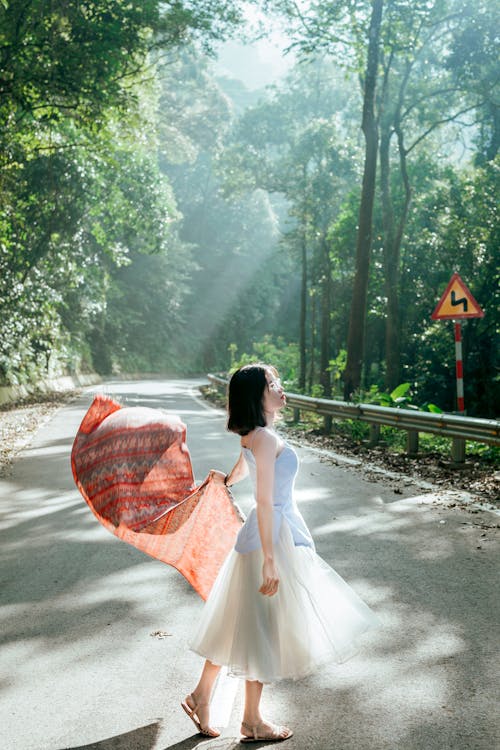 Photo Of Woman Standing In The Middle Of The Road