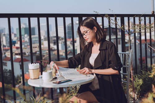 Woman in Black Blazer Reading Book