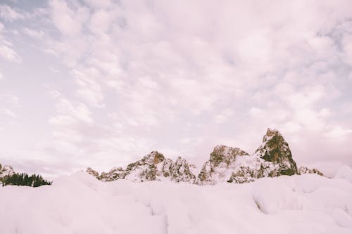 Free Photo Of Snow Covered Mountain Under Cloudy Sky Stock Photo