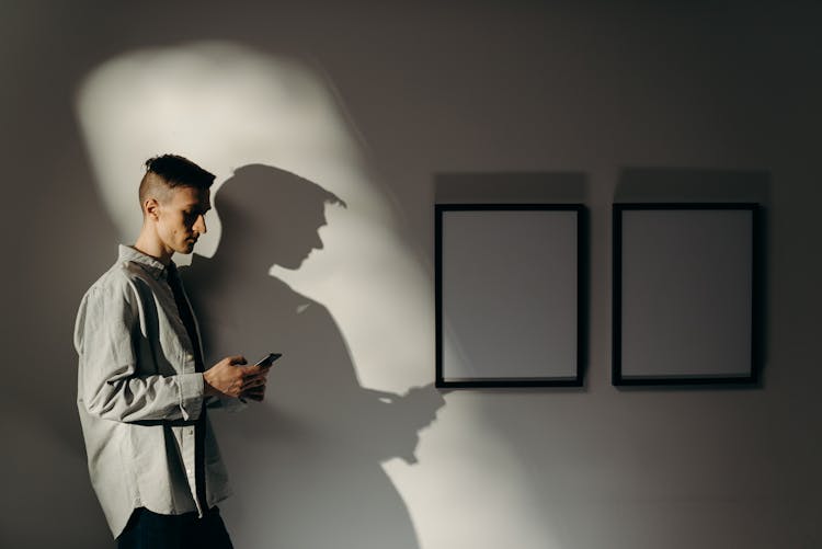 Man In White Dress Shirt Standing Near Wall