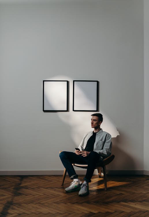 Free Man in Gray Dress Shirt Sitting on Black Chair Stock Photo