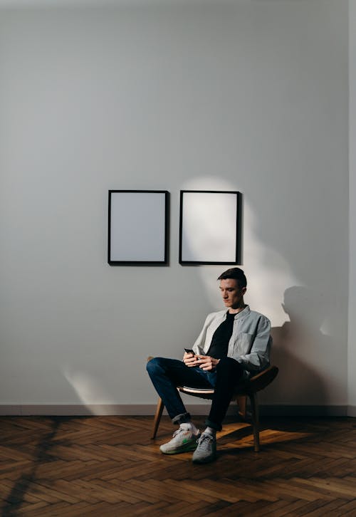 Free Man in White Dress Shirt Sitting on Black Chair Stock Photo