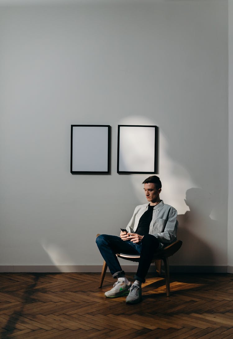 Man In White Dress Shirt Sitting On Black Chair