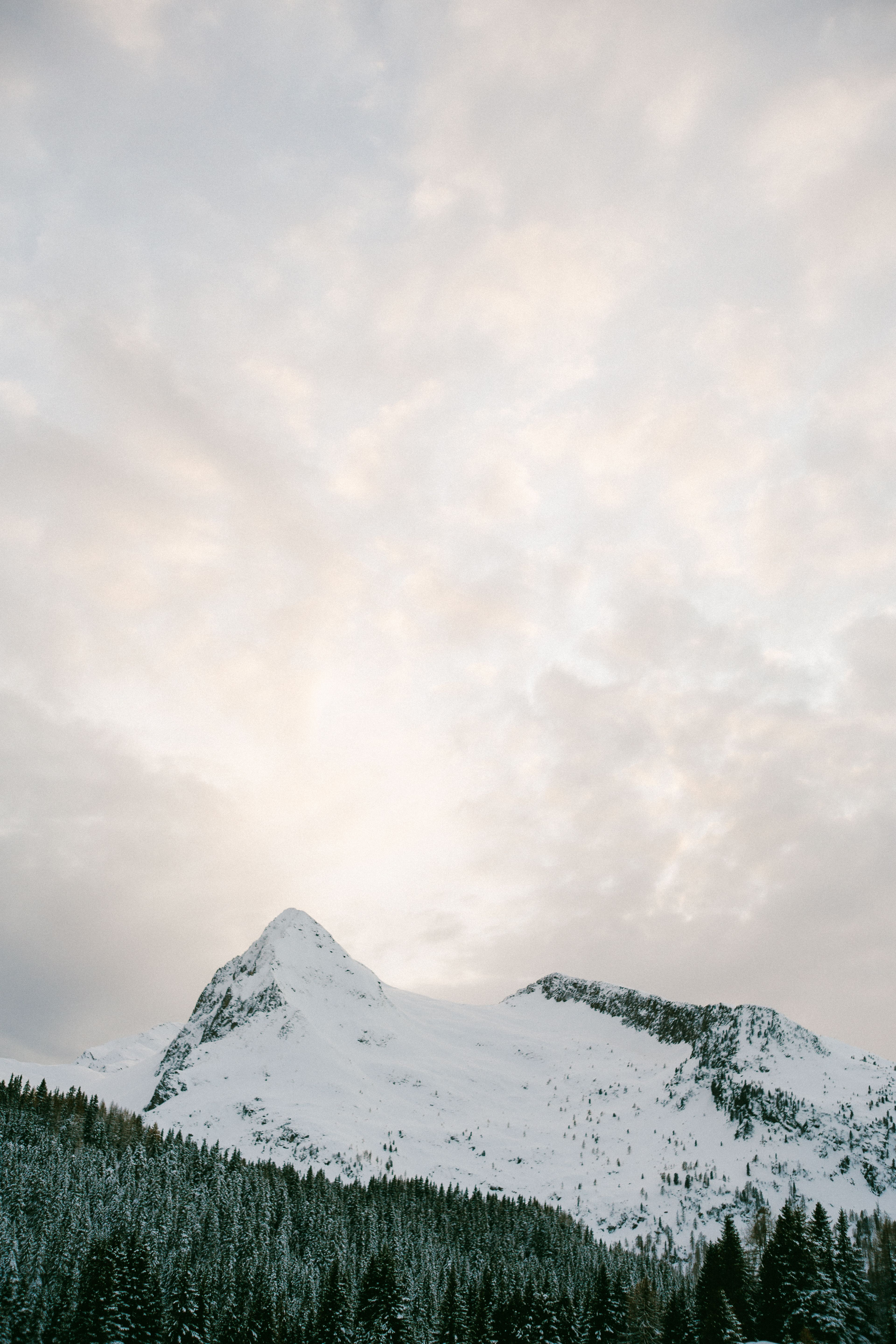 Photo Of Snow Covered Mountain Under Cloudy Sky · Free Stock Photo