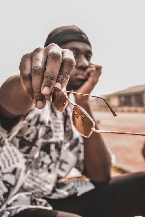 Photo Of Person Holding Framed Sunglasses