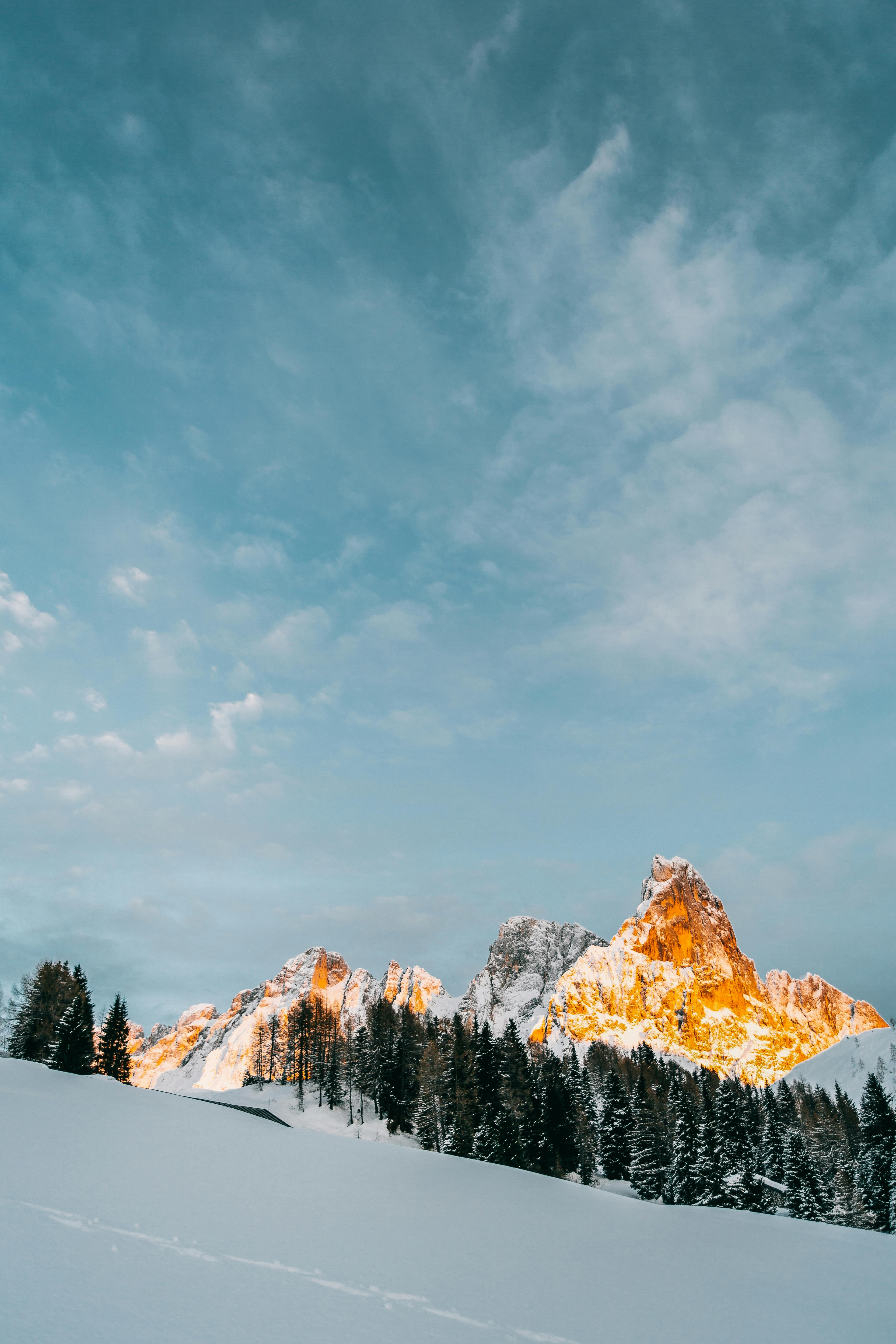 Snow Covered Mountain Under Cloudy Sky