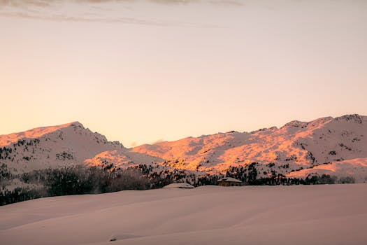 photo of snow capped mountains during dawn