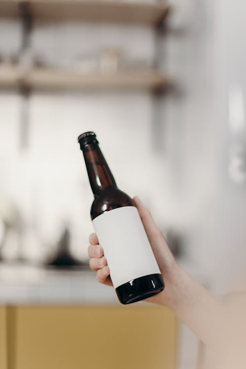 Free Person Holding White Labeled Bottle Stock Photo