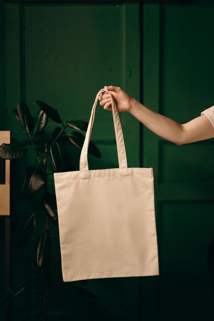 Cotton tote bag held against a colour backdrop, photo by cottonbro studio on Pexels