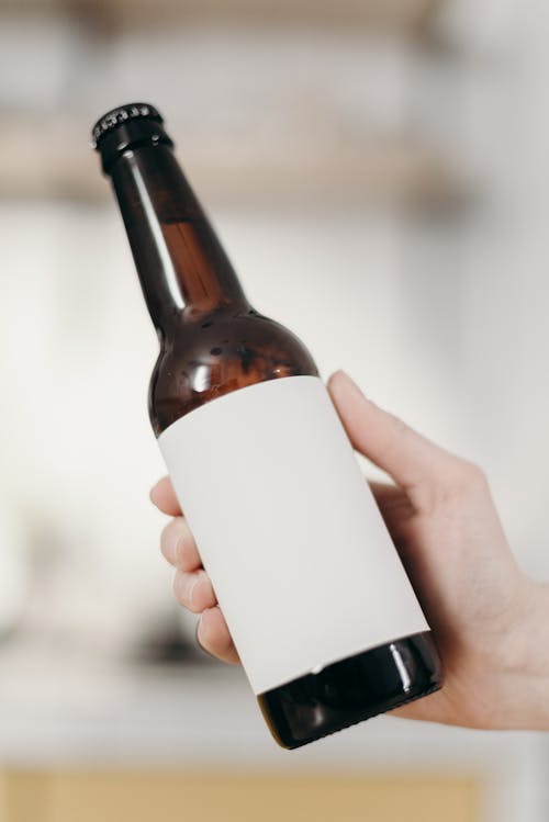 Free Person Holding White Labeled Bottle Stock Photo