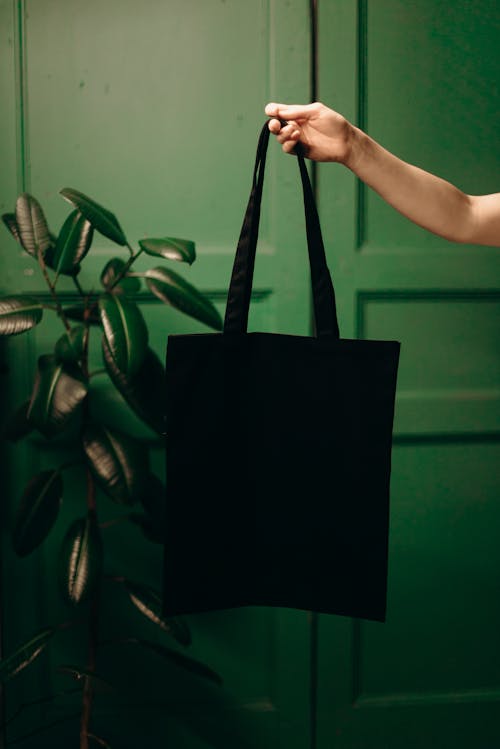 Free Photo Of Person Holding A Bag Stock Photo