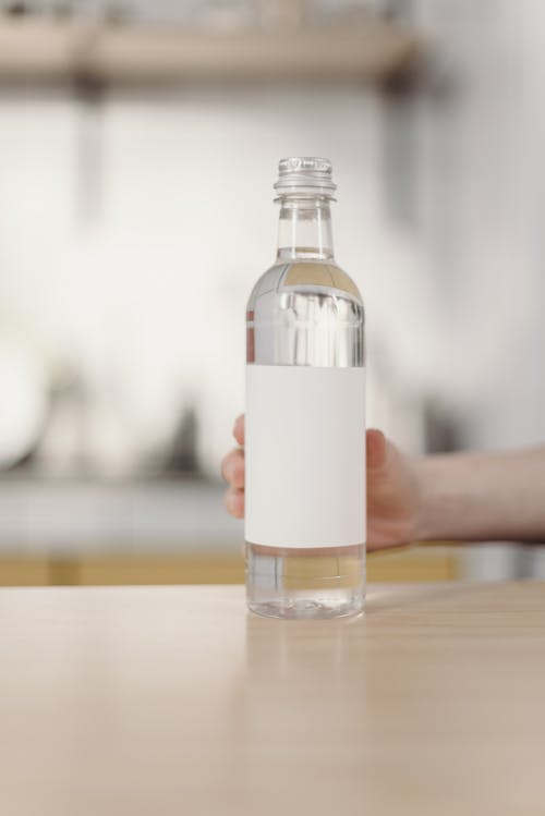 Photo Of Person Holding Bottle 