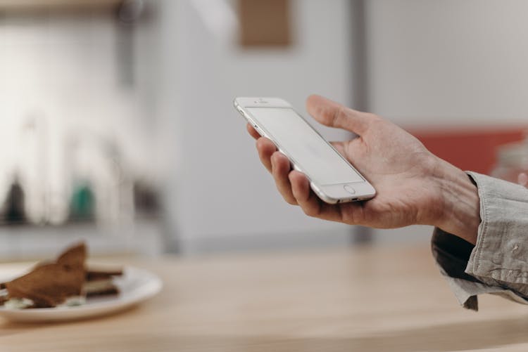 Person Holding White Iphone 5 C