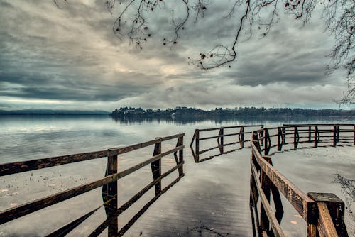 Brown Wooden Fence on Body of Water