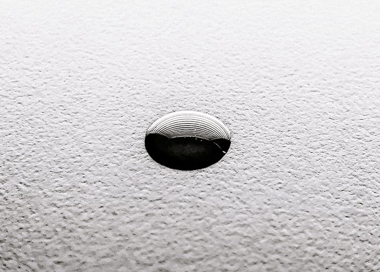 Small Ink Drop O White Textured Surface