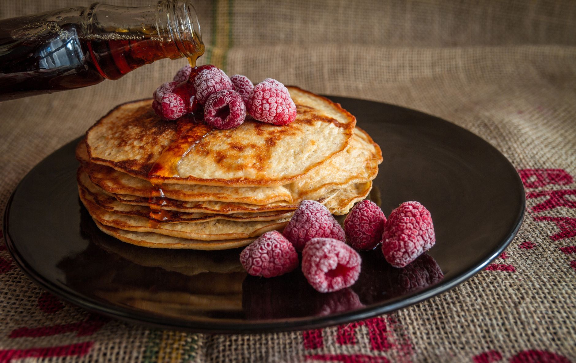 Stack of golden pancakes with syrup on a plate