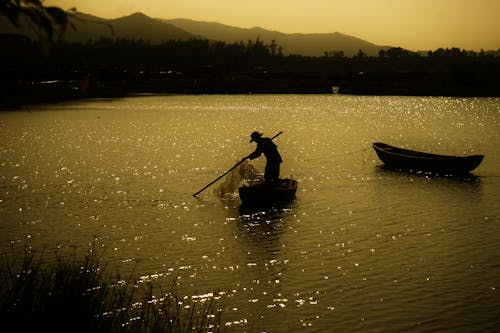 Photo Of Man Standing On Boat