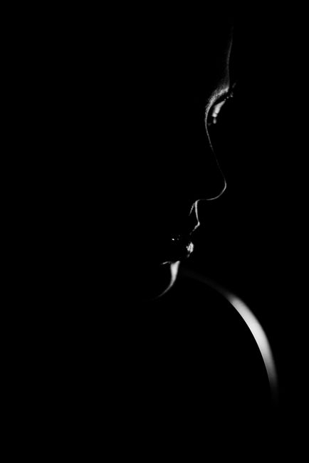 Dramatic black and white silhouette of a woman's face showcasing elegance and mystery.